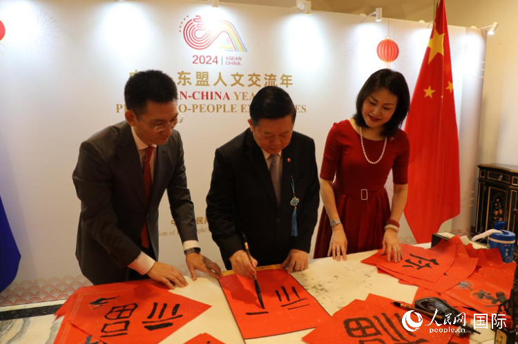 東盟秘書(shū)長(zhǎng)高金洪（中）在活動(dòng)現(xiàn)場(chǎng)寫(xiě)福字。人民網(wǎng)記者曹師韻攝