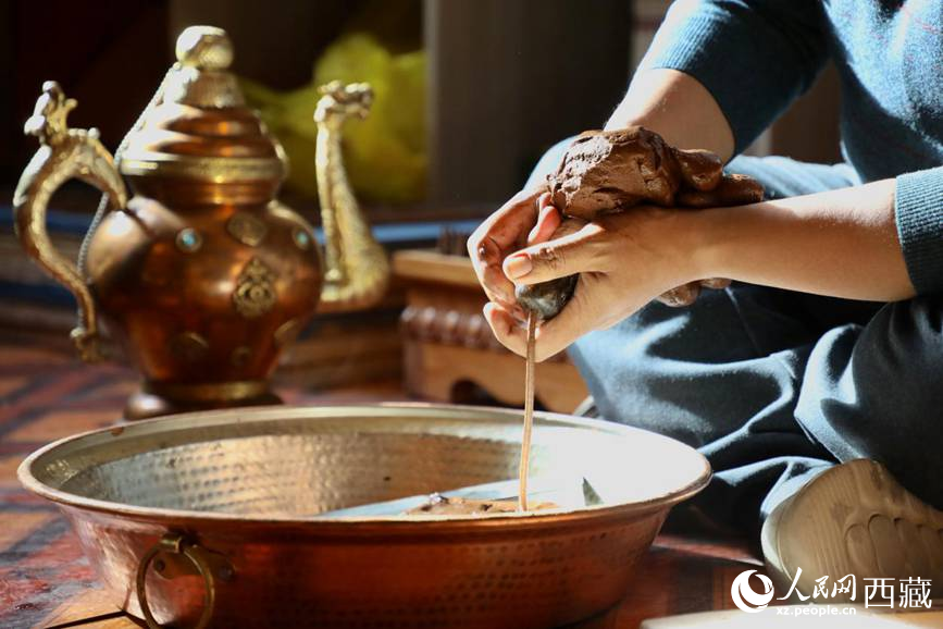 牛角鉆孔，將木泥擠出。人民網(wǎng)記者 次仁羅布攝