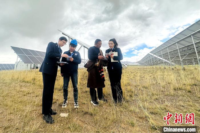 圖為稅務(wù)干部上門開展稅費(fèi)輔導(dǎo)?！》劫F龍 攝